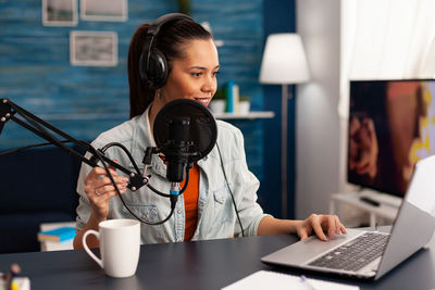 Smiling woman streaming while sitting at home