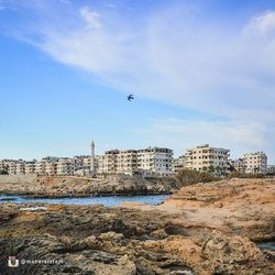 View of cityscape against blue sky