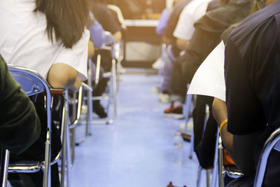 Rear view of people sitting on chair