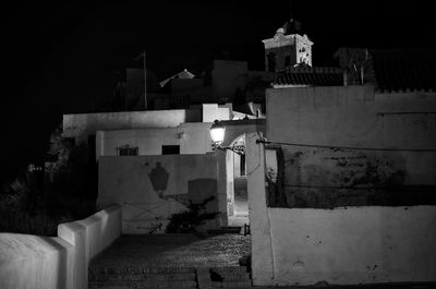 Illuminated building against sky at night