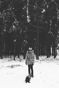 Full length of man standing on snow covered landscape