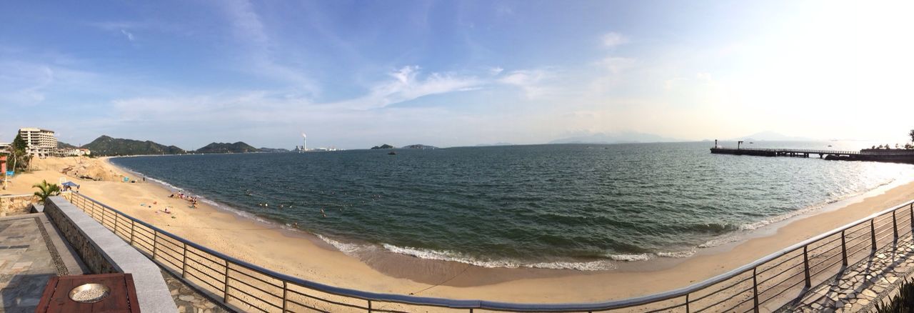 sea, water, sky, horizon over water, beach, scenics, panoramic, beauty in nature, built structure, shore, nature, tranquil scene, tranquility, architecture, cloud - sky, sunlight, transportation, coastline, idyllic, day