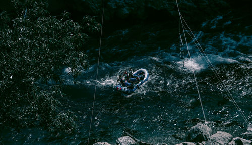 High angle view of men rafting on river