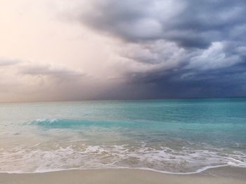 Scenic view of sea against cloudy sky