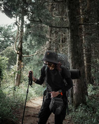 Full length of man standing in forest