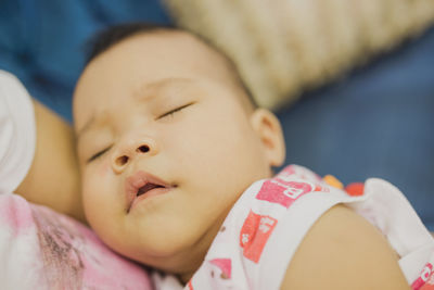 Close-up of baby girl at home