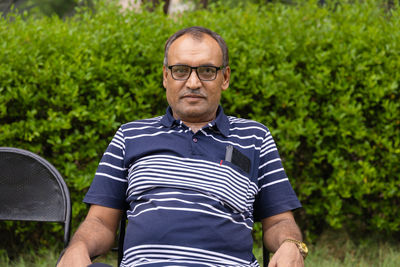 Isolated smiling man facial expression at outdoor park at evening from flat angle