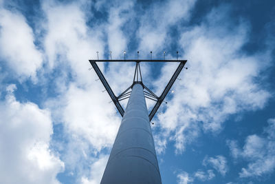 Low angle view of communications tower against sky