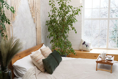 Still life details in home interior of light bedroom in bohemian chic style. breakfast on the bed