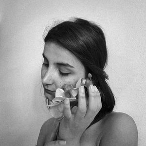 Close-up portrait of a young woman with eyes closed