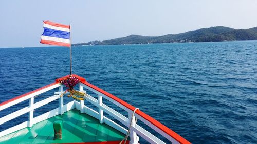 Boat sailing on sea against sky