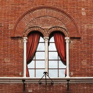 Low angle view of window on brick wall