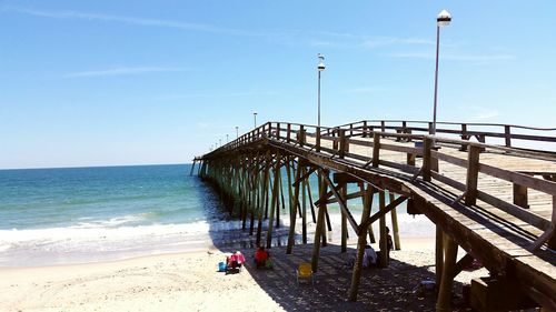 Scenic view of beach against blue sky