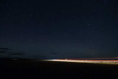 Scenic view of landscape against sky at night