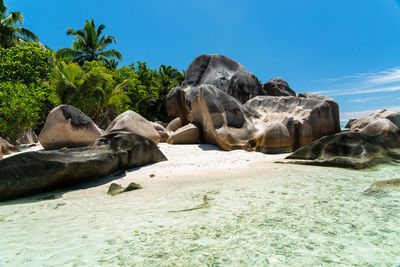 Rocks on beach against sky