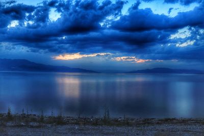 Scenic view of sea against storm clouds