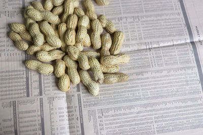 Close-up of peanuts on newspaper
