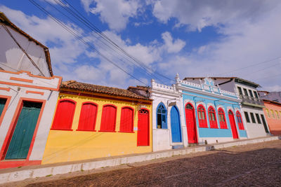 Low angle view of multi colored building against sky