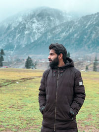 Young man standing on field