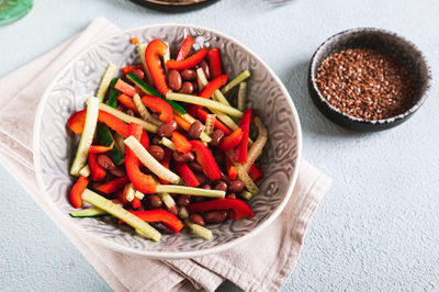 Vegetable salad of red beans, cucumber and fresh pepper in a bowl on the table