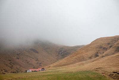 Scenic view of house on landscape against sky