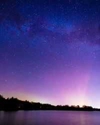 Scenic view of lake against star field at night