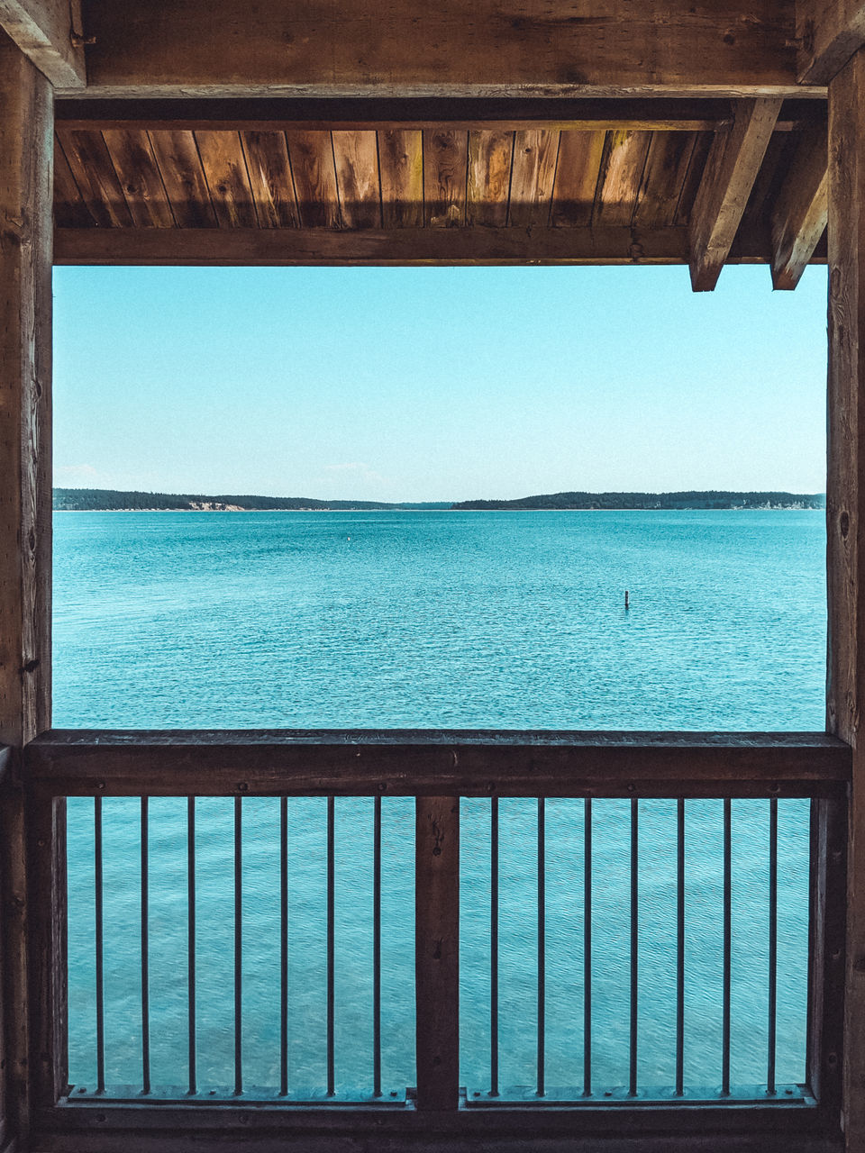 SCENIC VIEW OF SEA SEEN THROUGH WINDOW