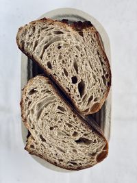 Close-up of bread on table against white background