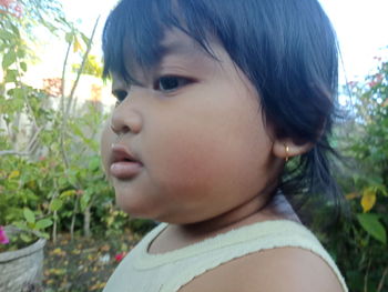 Close-up portrait of cute boy looking away