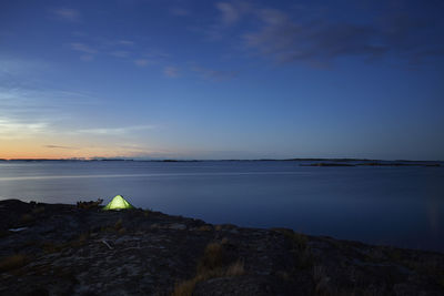 View of illuminated tent at sea