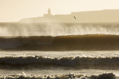 Scenic view of sea waves during sunny day