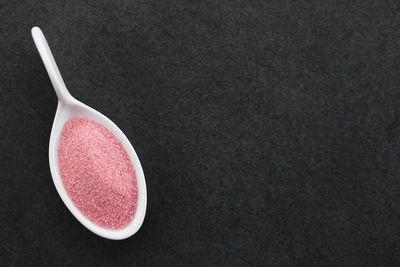 High angle view of pink apple against black background