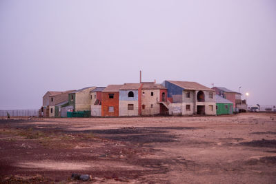 Built structures on field against clear sky