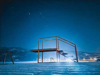 View of swimming pool against sky at night