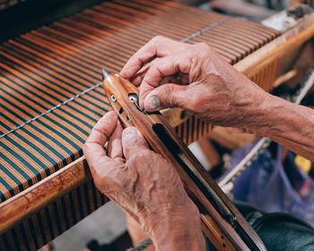 Midsection of person working on wood