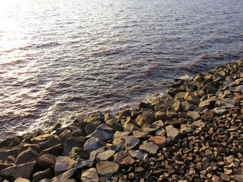 High angle view of stones on sea shore