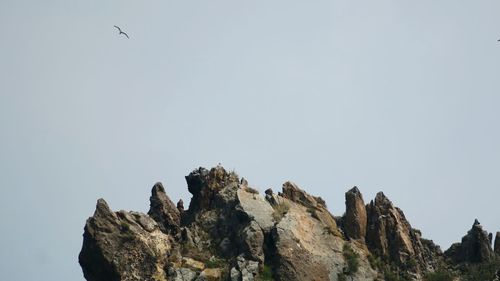 Low angle view of rock formations against clear sky