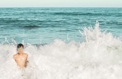 Man splashing water in sea