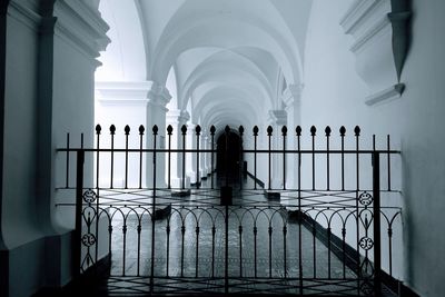 Rear view of people walking in corridor of building