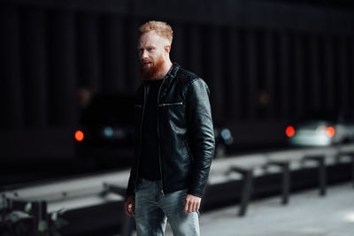 Full length portrait of young man standing in city