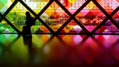 Reflection of silhouette people on glass window