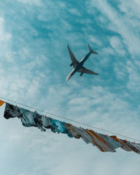 Low angle view of airplane flying in sky