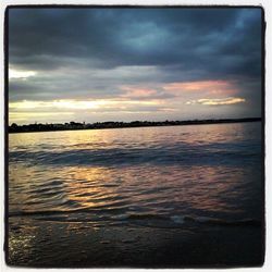 Scenic view of sea against cloudy sky