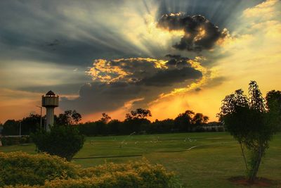 Scenic view of field against sky during sunset
