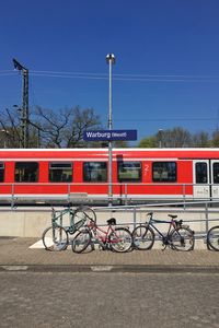 Bicycles parked by railing against train