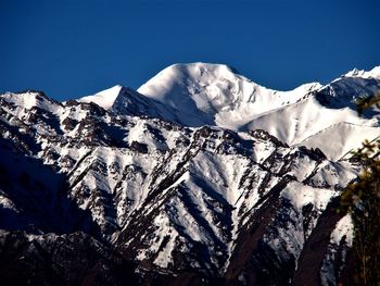 Scenic view of snowcapped mountains against clear sky