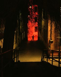 Man on illuminated chair at night