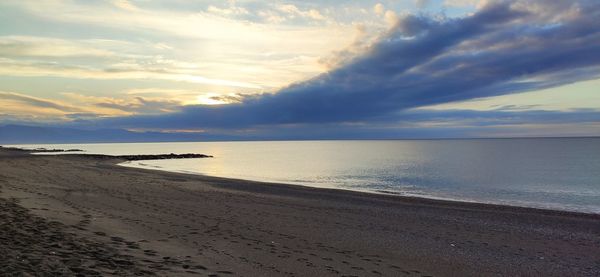 Scenic view of beach against sky during sunset