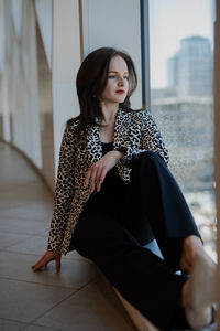 Young woman sitting on floor