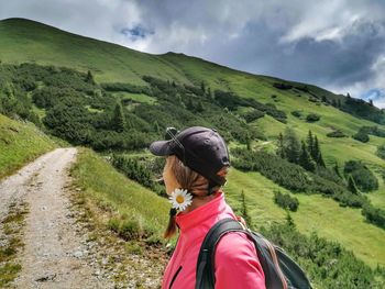 Rear view of woman looking at mountain against sky